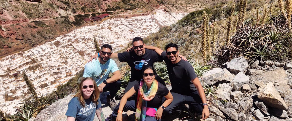 Group of happy friends at the Maras salt mines
